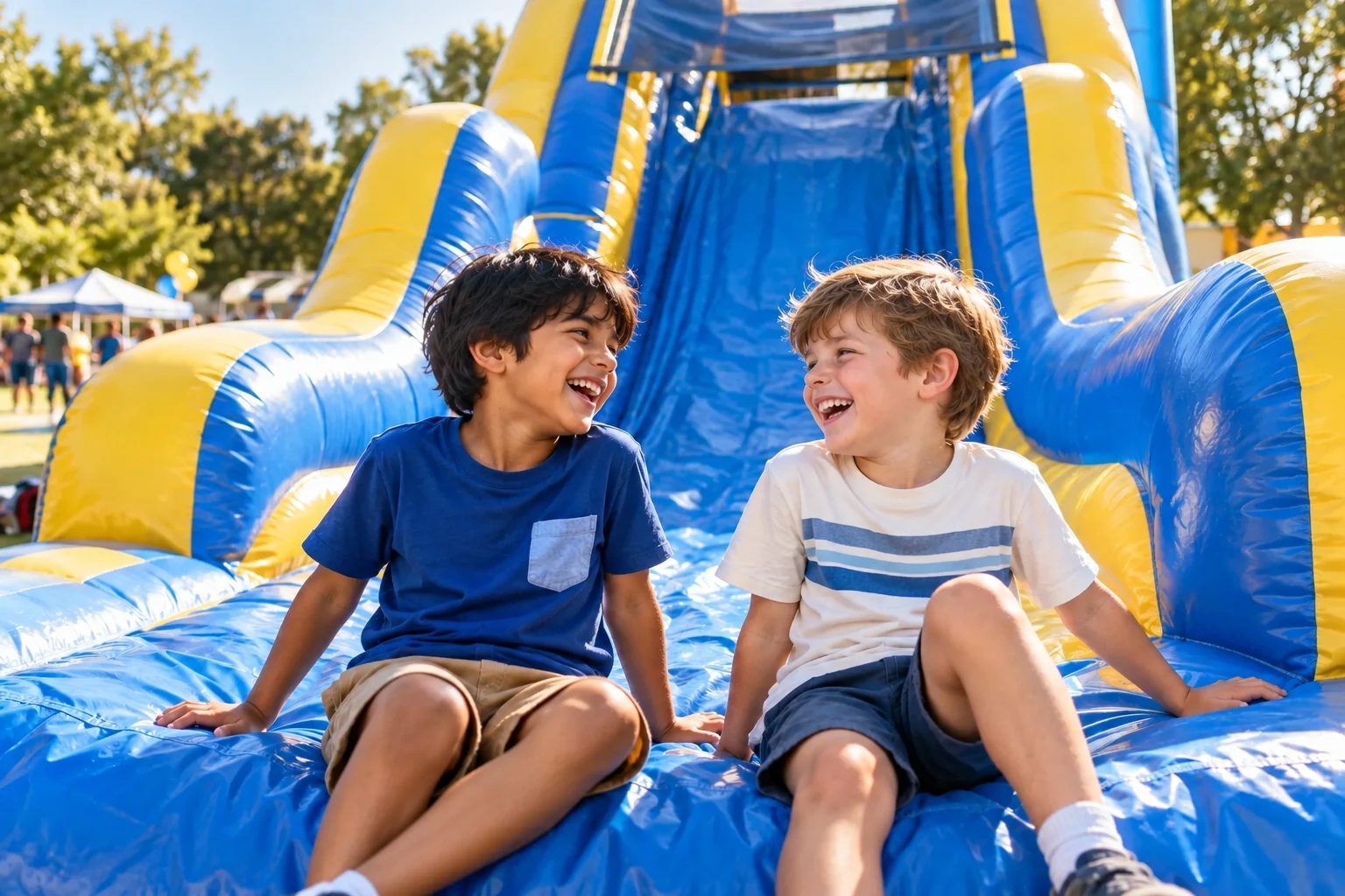 Promotional scene of two boys laughing at the bottom of an inflatable slide